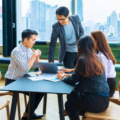 Marketing team collaborating on targeted campaigns to promote Korean software solutions in ASEAN countries